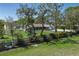 Expansive front yard view showcasing lush greenery, mature trees, and a charming playset at 3903 71St E St, Palmetto, FL 34221