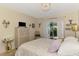Light bedroom with dresser, television, and sliding door access to a private outdoor patio at 4091 Center Pointe Pl # 40A, Sarasota, FL 34233