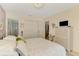 This bedroom features a closet, a dresser with a television, and a bathroom with a glass door shower at 4091 Center Pointe Pl # 40A, Sarasota, FL 34233