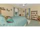 Bedroom showcasing a comfortable bed, sunny windows, and display shelves at 4091 Center Pointe Pl # 40A, Sarasota, FL 34233