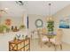 Comfortable dining room featuring a glass table, woven chairs, and adjacent kitchen view at 4091 Center Pointe Pl # 40A, Sarasota, FL 34233