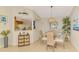 Charming dining area with rattan chairs, glass table, and stylish nautical decor at 4091 Center Pointe Pl # 40A, Sarasota, FL 34233