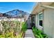 Pathway leading to a screened-in porch, surrounded by lush landscaping and colorful flowers at 4091 Center Pointe Pl # 40A, Sarasota, FL 34233
