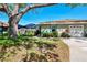 Charming one-story home with a well-manicured lawn, mature landscaping, and a screened pool enclosure at 4091 Center Pointe Pl # 40A, Sarasota, FL 34233