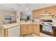Well-lit kitchen features sleek appliances, light cabinets, and a seamless transition into the dining area at 4091 Center Pointe Pl # 40A, Sarasota, FL 34233
