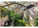 Screened garden area with wrought iron arbor, artificial turf, and lush landscaping features at 4091 Center Pointe Pl # 40A, Sarasota, FL 34233