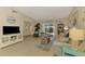 Cozy living room with coastal decor, light wood floors, and sliding door access to the outdoors at 4091 Center Pointe Pl # 40A, Sarasota, FL 34233