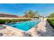Community pool area with clear blue water, a pool house, lounge chairs, and mature landscaping at 4091 Center Pointe Pl # 40A, Sarasota, FL 34233
