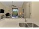 Modern living space featuring an open floor plan with a view from the kitchen to the living area and balcony at 4118 Central Sarasota Pkwy # 1636, Sarasota, FL 34238