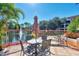Outdoor seating area with a table and chairs, set against a scenic lake and fountain backdrop at 4118 Central Sarasota Pkwy # 1636, Sarasota, FL 34238