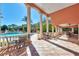 Relaxing poolside patio with tables, chairs, and view of large community pool at 4118 Central Sarasota Pkwy # 1636, Sarasota, FL 34238