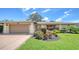 Charming single-story home featuring a well-manicured lawn and vibrant landscaping at 4848 Greywood Ln, Sarasota, FL 34235