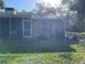 Backyard of home and enclosed patio, with a garden and lawn at 5013 Village Gardens Dr # 34, Sarasota, FL 34234
