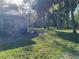 Spacious backyard featuring a well-manicured lawn and mature trees providing ample shade at 5013 Village Gardens Dr # 34, Sarasota, FL 34234