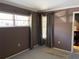 Bedroom with carpet flooring, window and view into the hallway of shelving at 5013 Village Gardens Dr # 34, Sarasota, FL 34234