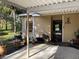 Inviting home exterior showcasing a covered carport, tidy landscaping, and a welcoming front entrance at 5013 Village Gardens Dr # 34, Sarasota, FL 34234