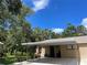Charming home exterior with covered parking, lush landscaping, and serene neighborhood views at 5013 Village Gardens Dr # 34, Sarasota, FL 34234