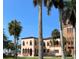 Elegant home with Mediterranean-style architecture, arched windows and lush landscaping, offering a luxurious waterfront lifestyle at 5013 Village Gardens Dr # 34, Sarasota, FL 34234