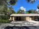 Single-story home featuring a covered parking area with lush landscaping at 5013 Village Gardens Dr # 34, Sarasota, FL 34234
