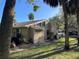 Charming single-story home featuring a private entrance, a grill, and a well-maintained lawn at 5013 Village Gardens Dr # 34, Sarasota, FL 34234