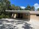 Single-story home featuring a covered parking area and well-maintained landscaping at 5013 Village Gardens Dr # 34, Sarasota, FL 34234