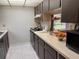 Efficient kitchen features light countertops, ample cabinet space, and modern microwave at 5013 Village Gardens Dr # 34, Sarasota, FL 34234