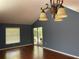Living room with hardwood floors, natural light, and sliding glass doors to the outdoors at 5013 Village Gardens Dr # 34, Sarasota, FL 34234