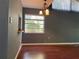 Bright living room featuring a high ceiling, neutral walls, and wood-look flooring, illuminated by windows at 5013 Village Gardens Dr # 34, Sarasota, FL 34234
