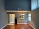 The living room has high ceilings, hardwood floors, chandelier, and a pass-through to the kitchen at 5013 Village Gardens Dr # 34, Sarasota, FL 34234