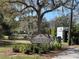 Inviting entrance sign for North Water Tower Park amidst mature trees and green landscape at 5013 Village Gardens Dr # 34, Sarasota, FL 34234