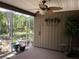 Enclosed lanai with a ceiling fan, plants and serene outdoor view at 5013 Village Gardens Dr # 34, Sarasota, FL 34234