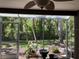 Outdoor patio with screened in enclosure featuring a view of the lush backyard at 5013 Village Gardens Dr # 34, Sarasota, FL 34234