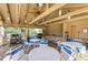 Outdoor poolside lounge area with cooking area, seating, and ceiling fan at 5013 Village Gardens Dr # 34, Sarasota, FL 34234