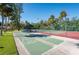 Shuffleboard and tennis courts for residents, surrounded by lush greenery and mature trees at 5013 Village Gardens Dr # 34, Sarasota, FL 34234