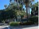 Well-maintained Village Gardens community sign surrounded by palm trees and attractive landscaping at 5013 Village Gardens Dr # 34, Sarasota, FL 34234