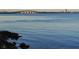 Picturesque waterfront view with calm water and a bridge in the distance against a clear sky at 5013 Village Gardens Dr # 34, Sarasota, FL 34234