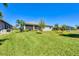 Spacious backyard features lush lawn, mature trees, and a screened lanai at 507 W Cashew, Punta Gorda, FL 33955