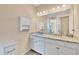 Well-lit bathroom with double vanity featuring white cabinets, granite countertop, and ample storage space at 507 W Cashew, Punta Gorda, FL 33955