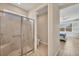 Modern bathroom with a glass-enclosed shower, tile surround, and a view into the bedroom at 507 W Cashew, Punta Gorda, FL 33955