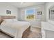 Bright bedroom with a large window, white plantation shutters, and wood-look floors at 507 W Cashew, Punta Gorda, FL 33955