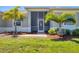 Inviting front entrance with a screened-in doorway and manicured landscaping at 507 W Cashew, Punta Gorda, FL 33955