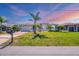 Charming single-story home with mature palm trees and a well-manicured lawn at 507 W Cashew, Punta Gorda, FL 33955