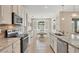 Bright kitchen featuring stone backsplash, stainless appliances, and breakfast nook at 507 W Cashew, Punta Gorda, FL 33955