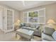 Cozy living room with large window, plantation shutters, and comfortable seating arrangements at 507 W Cashew, Punta Gorda, FL 33955