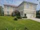 Elegant two-story home showcasing a tile roof, lush lawn and meticulously landscaped front yard, enhancing its curb appeal at 5121 Glade Fern Ct, Sarasota, FL 34238