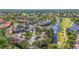 High angle view showcasing the community, lake, a winding golf course, and mature trees at 5275 Willow Links # 50, Sarasota, FL 34235