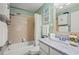 Cozy bathroom featuring a tub with tile surround, framed mirror, and marble countertop at 5275 Willow Links # 50, Sarasota, FL 34235