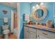 Charming bathroom with a decorative mirror, updated vanity, and tiled floors at 5275 Willow Links # 50, Sarasota, FL 34235