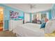 Inviting bedroom boasts a comfortable queen bed, a study desk, and serene blue walls at 5275 Willow Links # 50, Sarasota, FL 34235