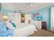 Comfortable bedroom with closet featuring a queen bed, closet and blue walls at 5275 Willow Links # 50, Sarasota, FL 34235